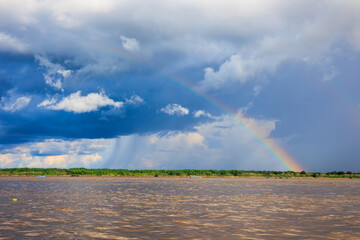 Rainbow in the amazon sky, over the great amazon river, Iquitos Peru