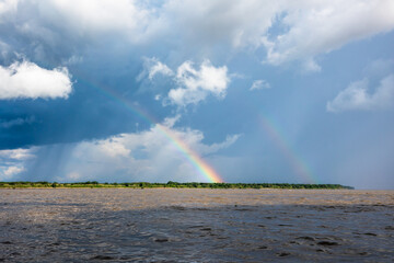 Rainbow in the amazon sky, over the great amazon river, Iquitos Peru