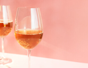 Glasses of sparkling drink, celebration party on pink background, Christmas cocktails, cider , kombucha.