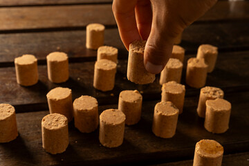 A guy's hand taking one Sweet Brazilian Peanut Called Paçoca