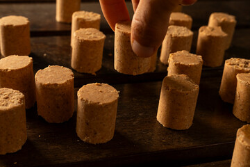 A guy's hand taking one Sweet Brazilian Peanut Called Paçoca