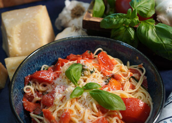 A classic Italian pasta dish, Capellini Pomodoro with fresh tomatoes, basil and garlic. Making an Italian meal for dinner using fresh ingredients from the garden.
