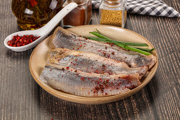 Salted marinated herring fillet with spices