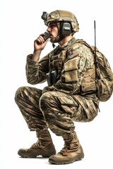 Fototapeta premium Camouflaged soldier crouching, using radio, backpack.