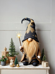 Photo of a Christmas gift a cute dwarf gnome on a wooden board holding a magic wand with a spakler on a white wooden background with christmas decoration