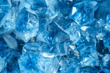 Blue Crystal Mineral Stone. Gems. Mineral crystals in the natural environment. Texture of precious and semiprecious stones. Seamless background with copy space colored shiny surface of precious stones