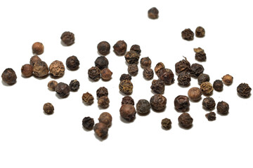 Hot bitter black peppercorns lie on the table.