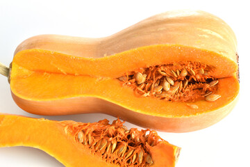 A sweet ripe pumpkin with a piece cut out of it.