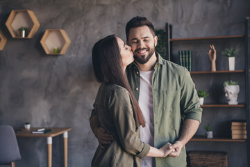 Photo of charming cheerful married guy lady wear casual shirts kissing holding arms indoors room home house