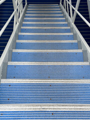 Gangway with striped risers, for boarding and disembarkation, on a small cruise ship in port