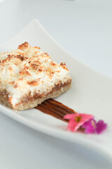 plate of coconut cake dessert with flower decoration