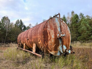 rusty water tank. A rusty water tank in the middle of the forest.