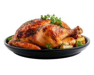 Succulent roasted chicken garnished with herbs on black plate