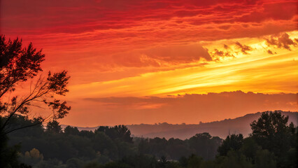 Obraz premium stunning sunset with intense red blending into burnt orange and golden hues, creating dramatic sky over serene landscape