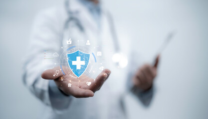 Doctor holding a holographic shield with a medical cross, symbolizing healthcare protection,...
