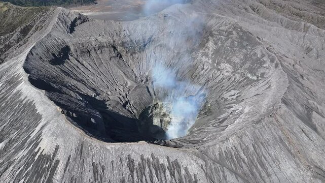 Drone view fly to Bromo volcano crater and tilt down, East Java, Indonesia 