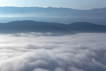 The weather is hot and humid, with a lot of water vapor creating a sea of mist in the foreground in...