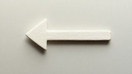 Simple Wooden Arrow Sign Pointing Left on a Neutral Background, Ideal for Directional Guidance in Design, Photography, and Creative Projects