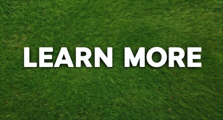 Learn More white lettering on grass background