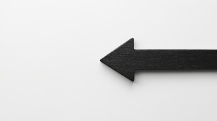 Obraz premium Minimalist Black Arrow Symbolizing Direction on a Smooth White Background Ideal for Use in Design, Business Concepts, or Creative Presentations