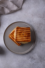 Grilled sandwich with ham and melted cheese