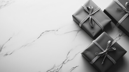 Black and white, flat lay of wrapped gifts on a marble surface, with space for text, top view