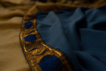 Medieval blue fabric texture background with details in gold