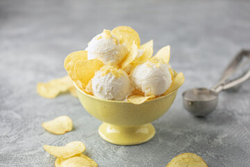 Sweet and salty vanilla ice cream balls and potato chips. Trendy american ice cream.