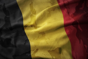 colourful waving flag of belgium on the old army khaki texture background. military concept.