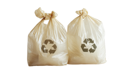 Overflowing trash bags with recycle symbol await curbside collection two