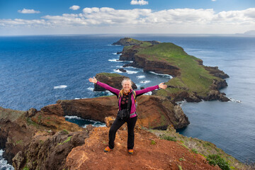Tourists on hiking path on Ponta de Sao Lourenco Madeira Portugal. Green landscape cliffs and...