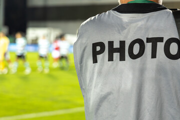 Photographer at football match.  Professional photographer shoots a soccer match at the stadium