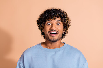 Fototapeta premium Photo of impressed funky guy dressed blue sweatshirt open mouth isolated beige color background