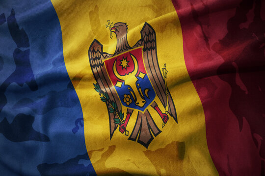 colourful waving flag of moldova on the old army khaki texture background. military concept.