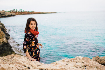 a young woman on rocky coast with turquoise water of Ayia Napa, Cyprus