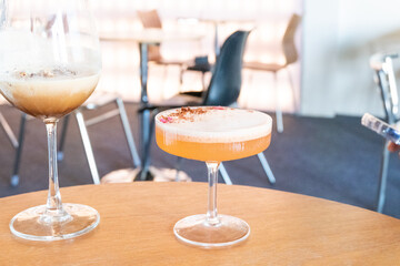 Glass of two Mocktail on table,female hand swirling red wine in wine glass,table for two,Friends cheering with wineglasses,eating and holidays concept.