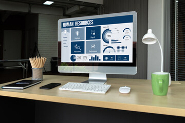 Human resources management software on computer screen helping human resources employee to manage recruitment, payroll, staff searching and KPI evaluation snugly