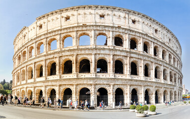 Rome, Italy - April 09, 2024: Ruins of the Coliseum with tourists strolling among the...