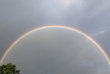 Rainbow's Arc A holographic rainbow arching across the sky its c