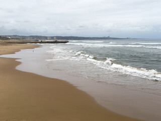 Durban beach, palm trees and stormy indian ocean, South Africa. 