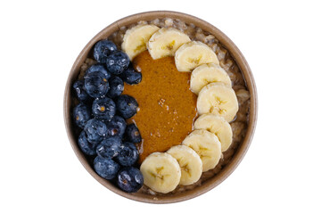 Perfect breakfast with whole oat, oat milk, chia seeds, banana, fresh blueberries, natural peanut butter and honey on white background