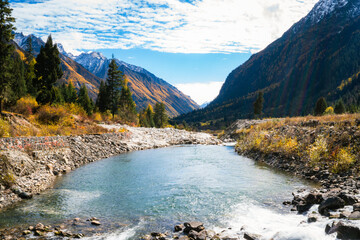 snow mountains,blue waters, seabuckthorn fir and sunshine of the outdoor natural landscape forest...
