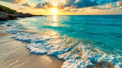 A stunning ocean sunset paints the sky with vibrant hues, casting a warm glow over turquoise waves and rocky cliffs.