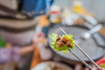 Savor a tasty bite of grilled meat wrapped in fresh lettuce, perfect for BBQ lovers