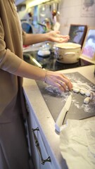 Happy attractive young woman housewife preparing breakfast for family. Mom stands near the kitchen stove and prepares dinner