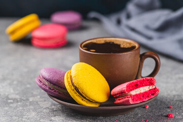 A cup of espresso coffee with macaroni cookies