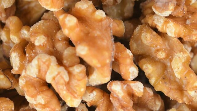 Shelled walnuts in a heap. Peeled walnuts on a rotating base. The concept of healthy nutrition, unsaturated fatty acids, vitamin B and iron