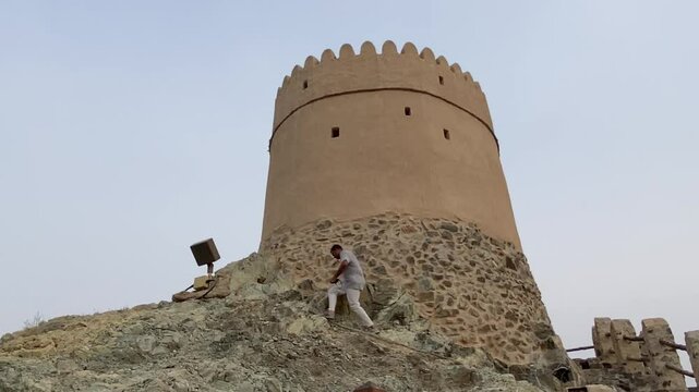 A young Man Anjoy Fort of Hatta heritage village tourist spot scenery in Hatta town