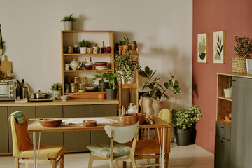 Well-organized modern kitchen featuring wooden shelves and potted plants, creating a welcoming...