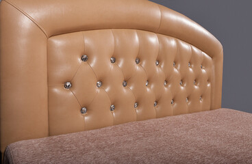 Soft headboard made of genuine leather with buttons. Upholstery of the headboard in the Capitonne...